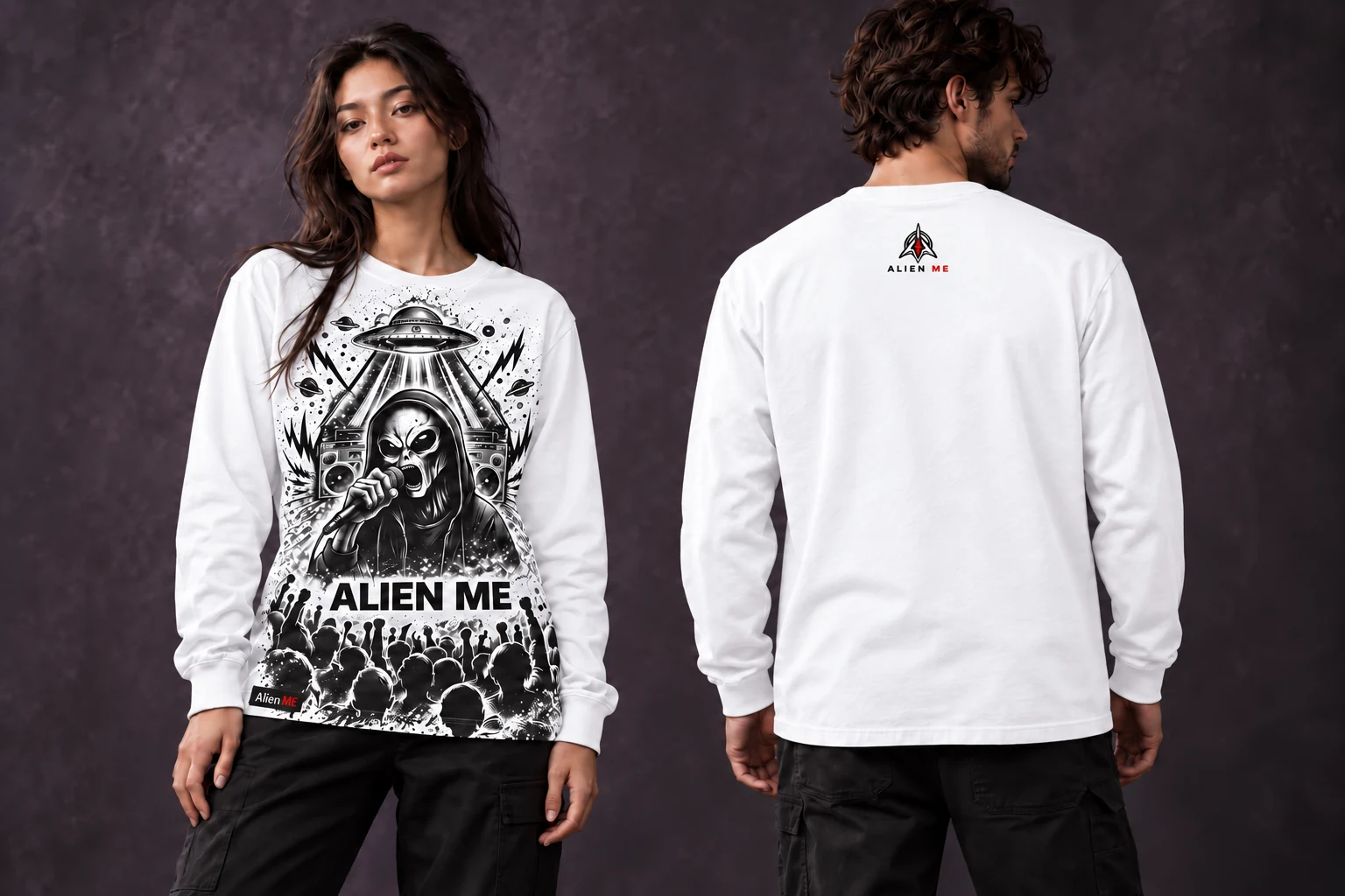 Two adult models wearing the true white Performer Long Sleeve, showing the full-height black and charcoal front illustration down to the bottom hem, plain sleeves and a small upper-back AM mark